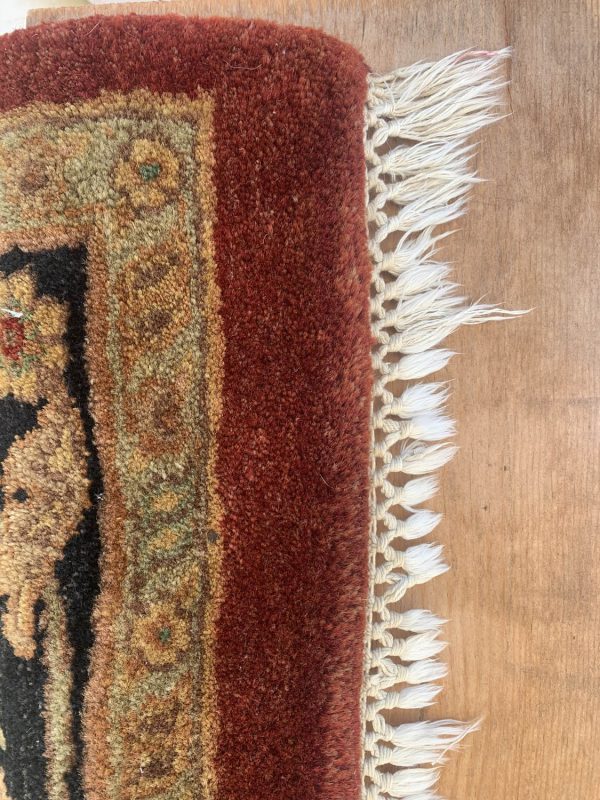 High-quality rug with intricate patterns and fringed edges.